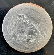 2014 quarter broadstrike error with smooth edge and expanded diameter compared to normal quarter